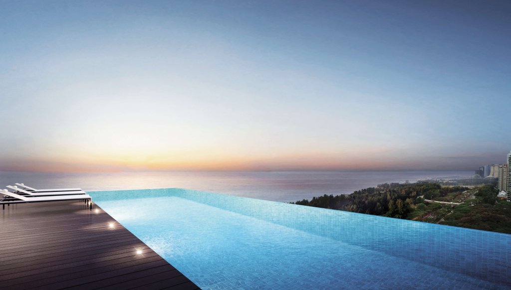 Coastline Residences rooftop infinity pool at dusk overlooking the sea