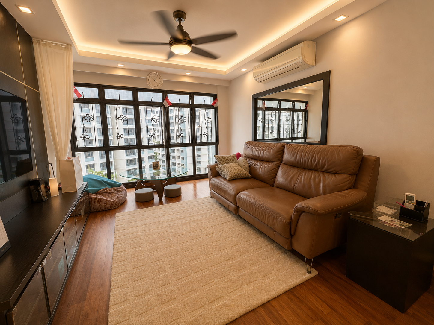 Renovated open-plan living room at 654C Jurong West Street 61 with leather sofa and floor-to-ceiling windows